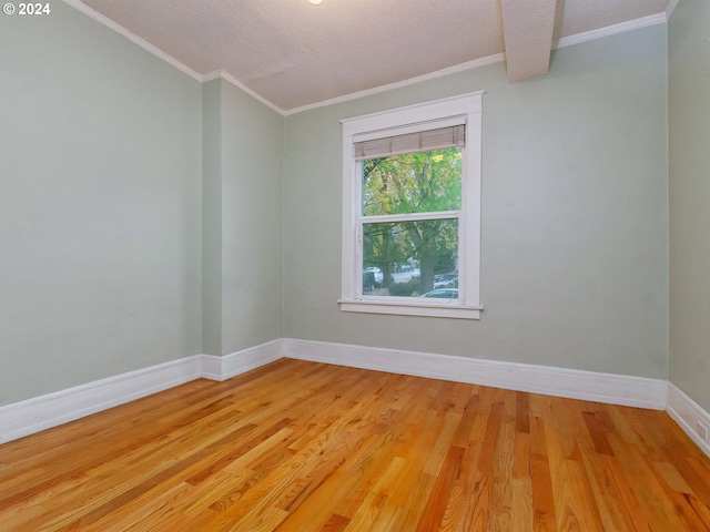 empty room featuring light hardwood / wood-style flooring and a textured ceiling