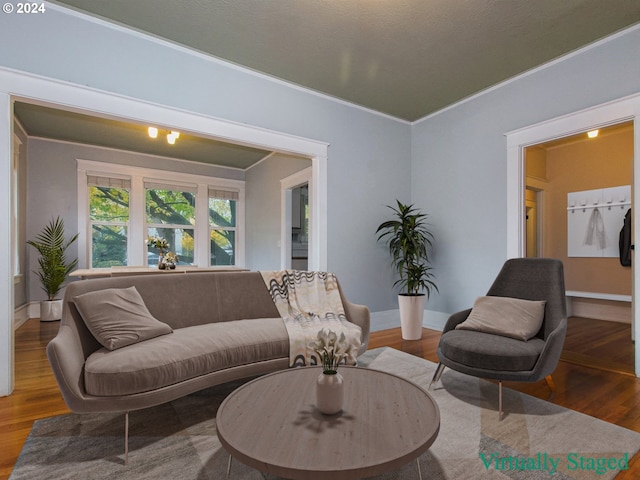 living room with ornamental molding and dark hardwood / wood-style flooring