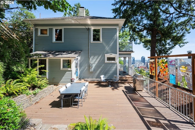 rear view of house featuring a wooden deck