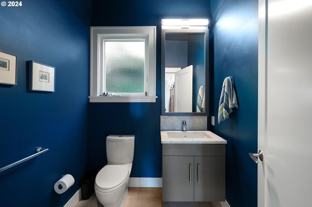 bathroom featuring toilet, vanity, and tile patterned floors