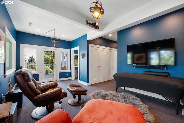 living room with a textured ceiling and carpet floors