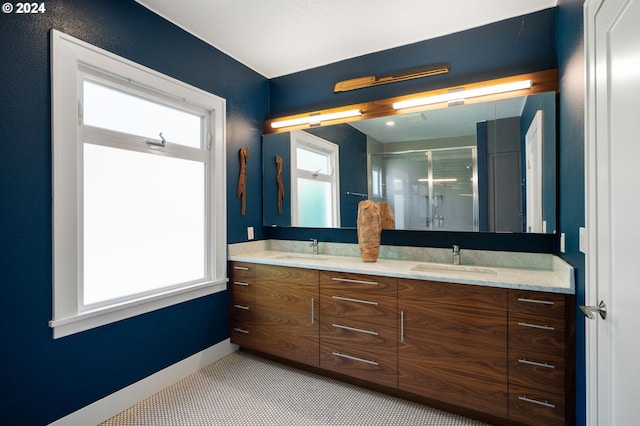 bathroom featuring an enclosed shower, vanity, and plenty of natural light