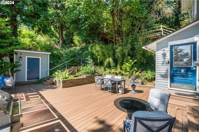 wooden terrace featuring a shed