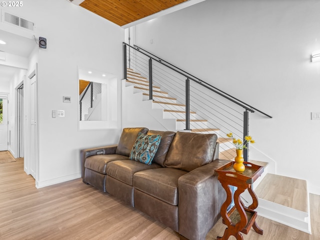 14581 NW Larson Rd Unit 7, Portland, OR 97231 - living area with light wood-type flooring, baseboards, visible vents, stairs, and wood ceiling