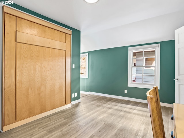 unfurnished bedroom with a closet and wood-type flooring