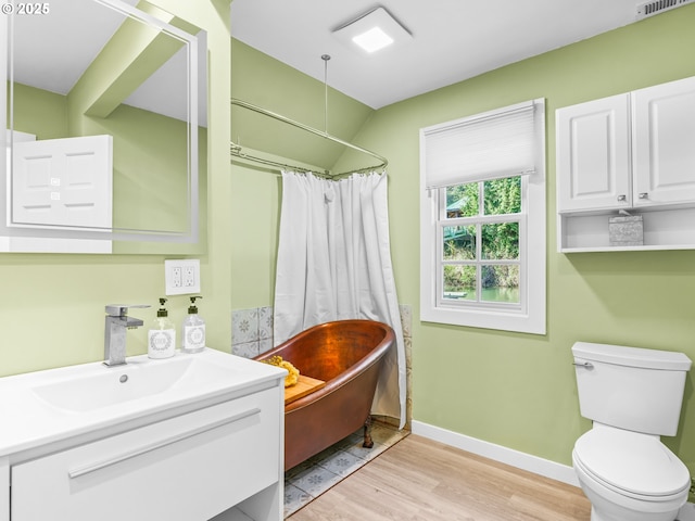 14581 NW Larson Rd Unit 7, Portland, OR 97231 - full bath with wood finished floors, a bathing tub, vanity, baseboards, and toilet