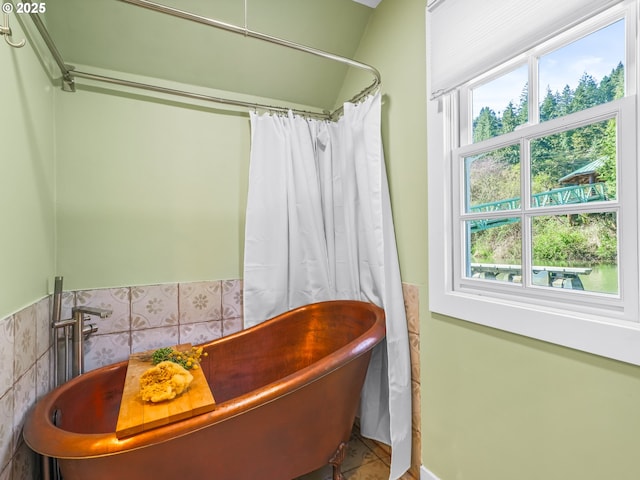 14581 NW Larson Rd Unit 7, Portland, OR 97231 - full bath featuring curtained shower, tile walls, a freestanding tub, and wainscoting