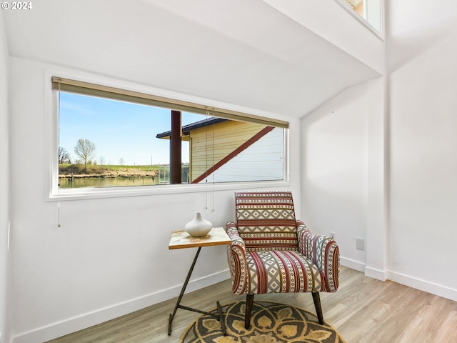 living area featuring a water view and light wood-type flooring