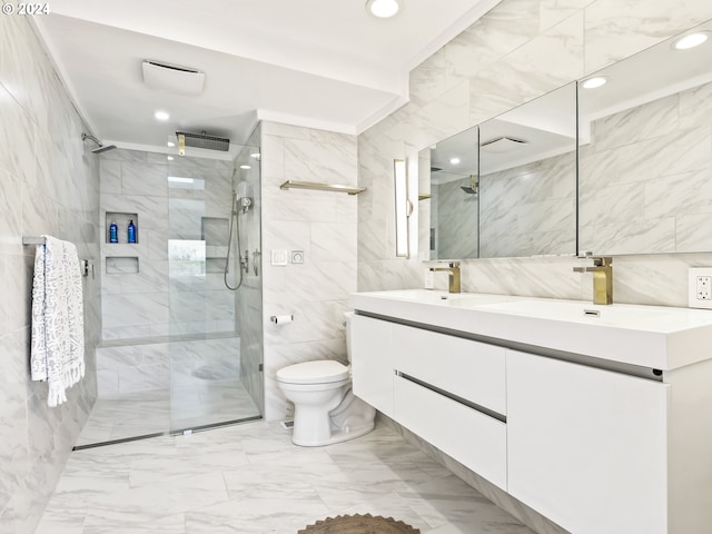 bathroom with tile walls, vanity, toilet, and walk in shower