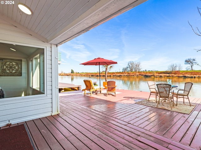 wooden deck featuring a water view