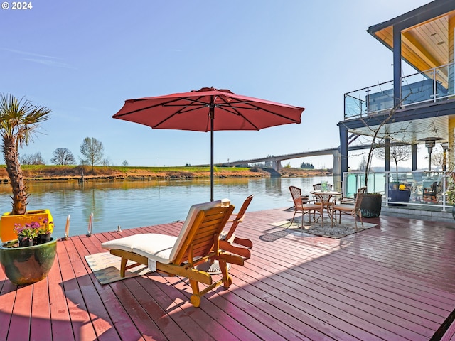 view of dock featuring a water view and a balcony