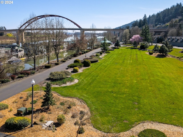 view of property's community with a yard and a water view