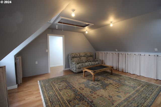 living area featuring lofted ceiling and light wood-type flooring