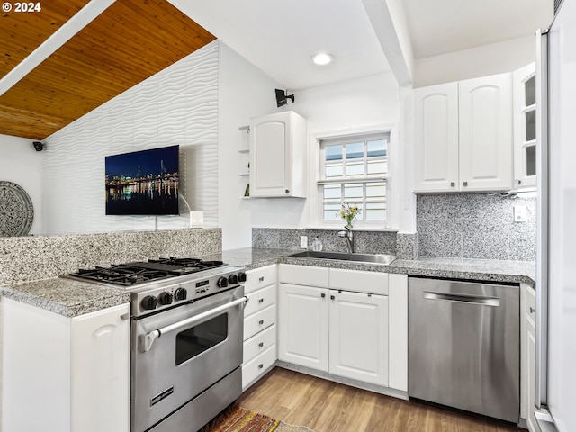 kitchen featuring sink, appliances with stainless steel finishes, white cabinets, and light hardwood / wood-style floors