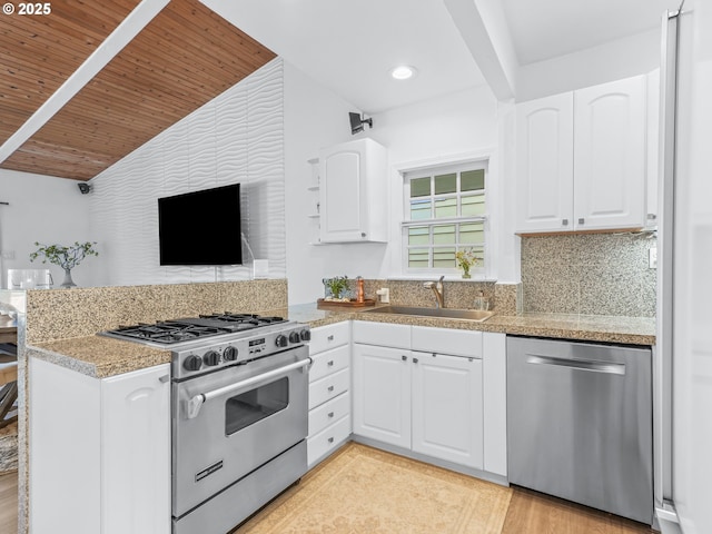 14581 NW Larson Rd Unit 7, Portland, OR 97231 - kitchen featuring a peninsula, a sink, white cabinetry, wooden ceiling, and appliances with stainless steel finishes