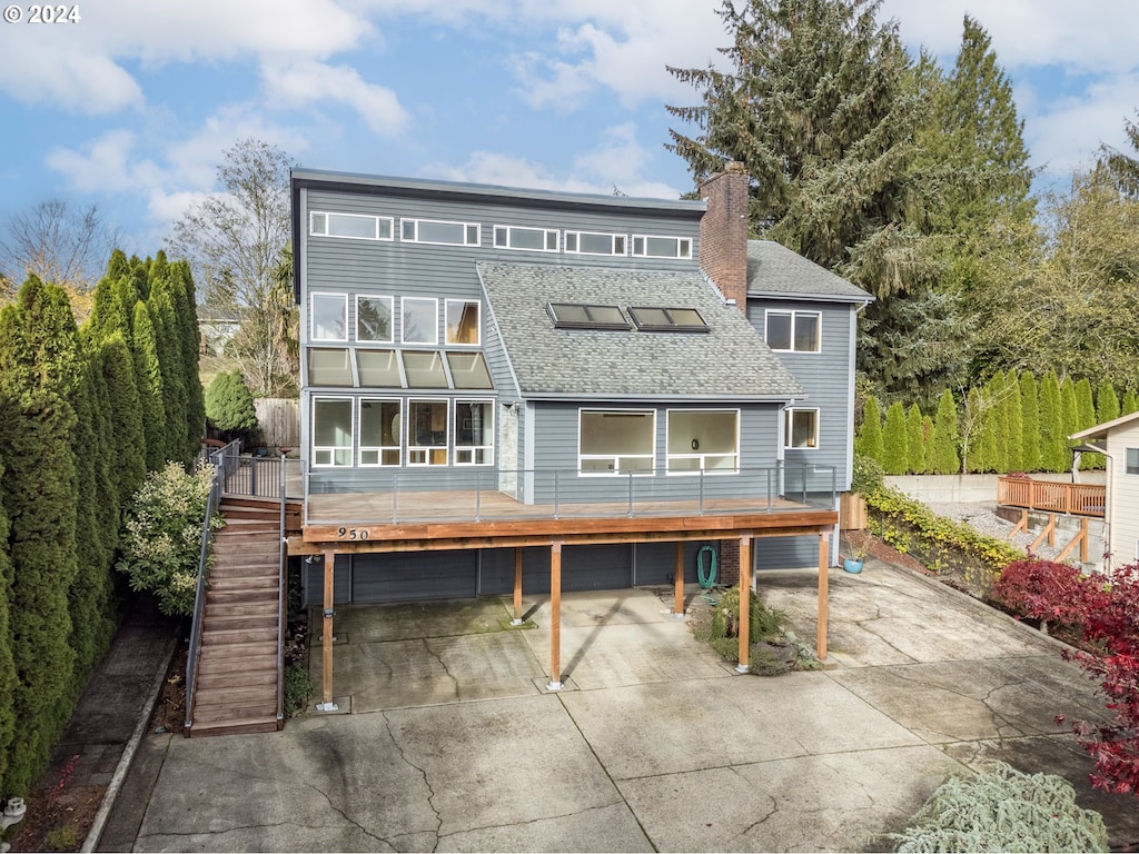 rear view of property featuring a garage