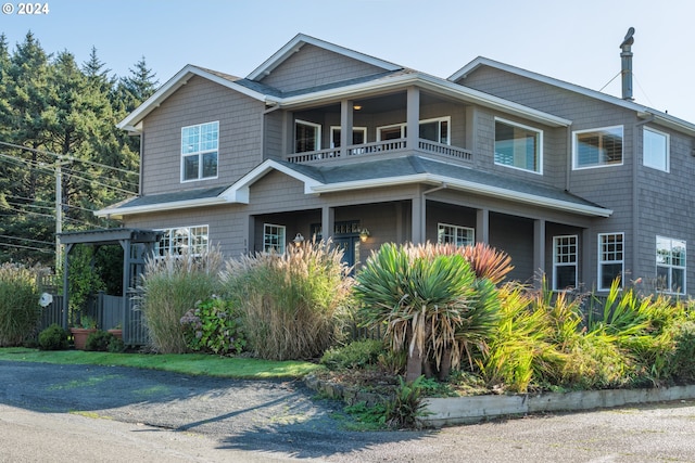 craftsman-style home with a porch and a balcony