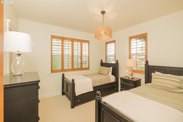 bedroom featuring light carpet