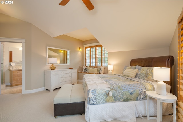 carpeted bedroom featuring ceiling fan, ensuite bath, and vaulted ceiling