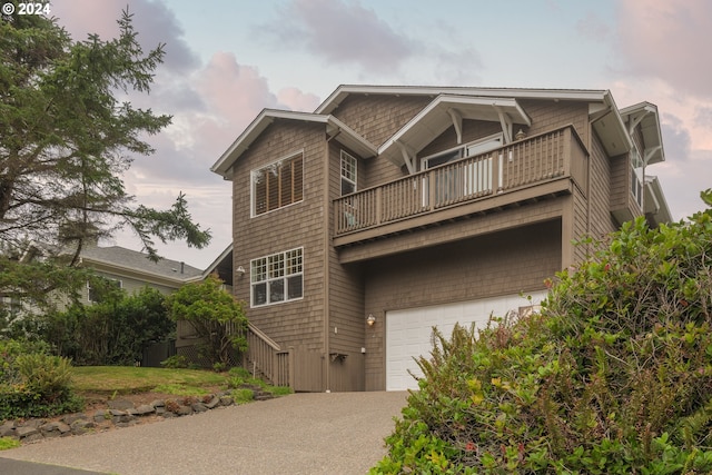 view of front of house featuring a garage and a balcony