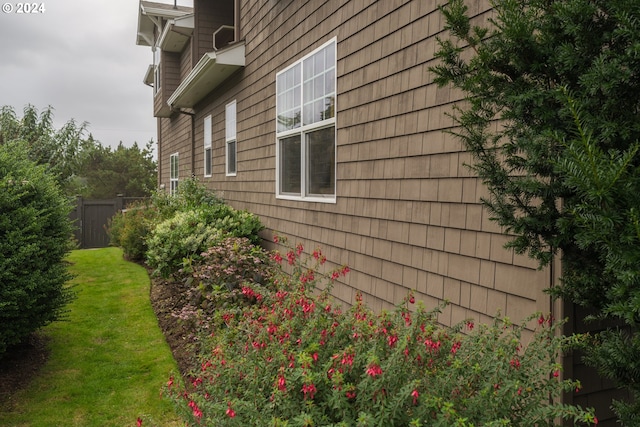 view of side of home with a lawn