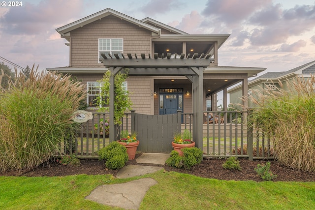 view of front of property featuring a front lawn and a pergola