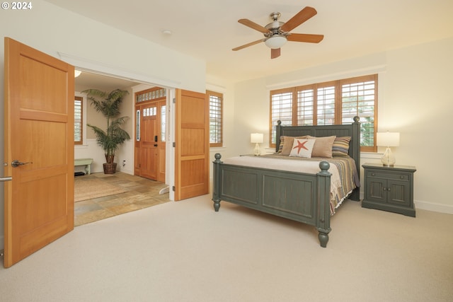 bedroom with light carpet and ceiling fan