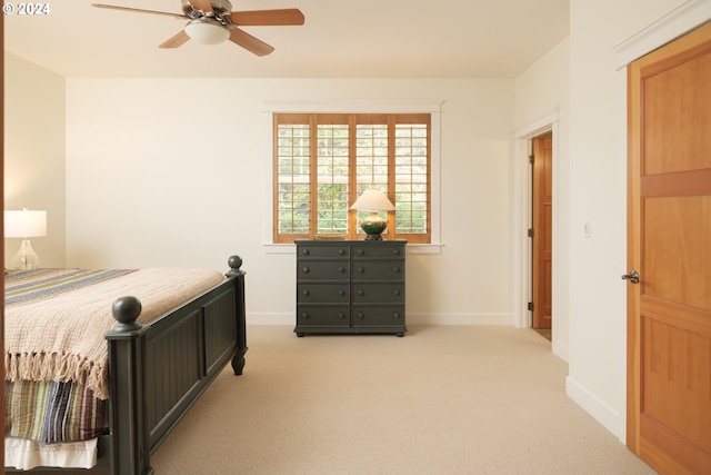 bedroom with light carpet and ceiling fan