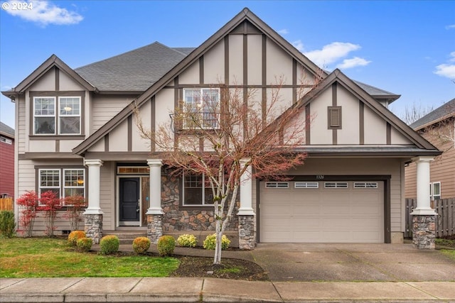 tudor-style house featuring a garage