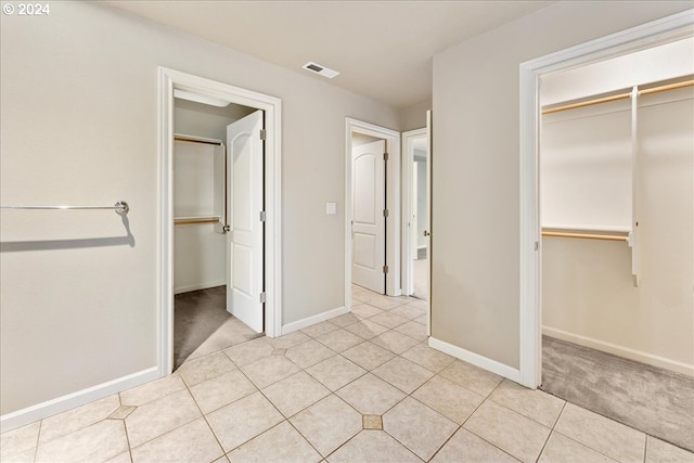 unfurnished bedroom with light tile patterned floors and a closet