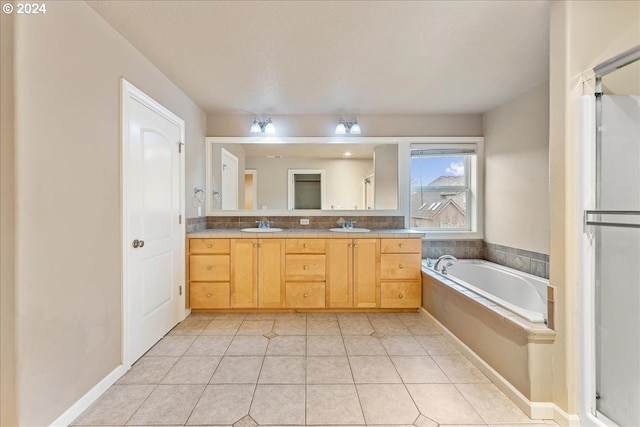 bathroom featuring tile patterned flooring, vanity, backsplash, and a tub to relax in