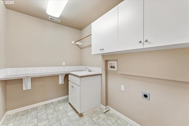 clothes washing area with electric dryer hookup, cabinets, sink, and hookup for a washing machine