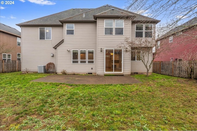 rear view of property featuring central AC, a yard, and a patio