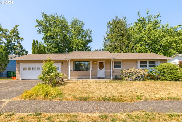 single story home featuring a front yard and a garage