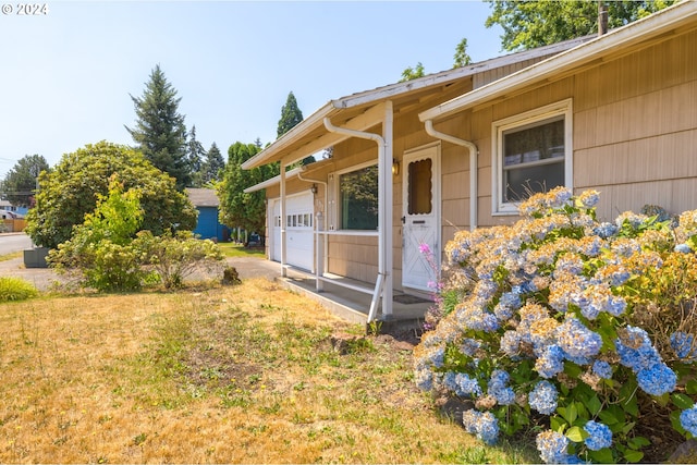 exterior space with a yard and a garage