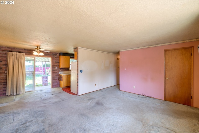 unfurnished living room with a textured ceiling, ceiling fan, and carpet flooring