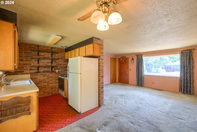 kitchen with white appliances, ceiling fan, dark carpet, and sink