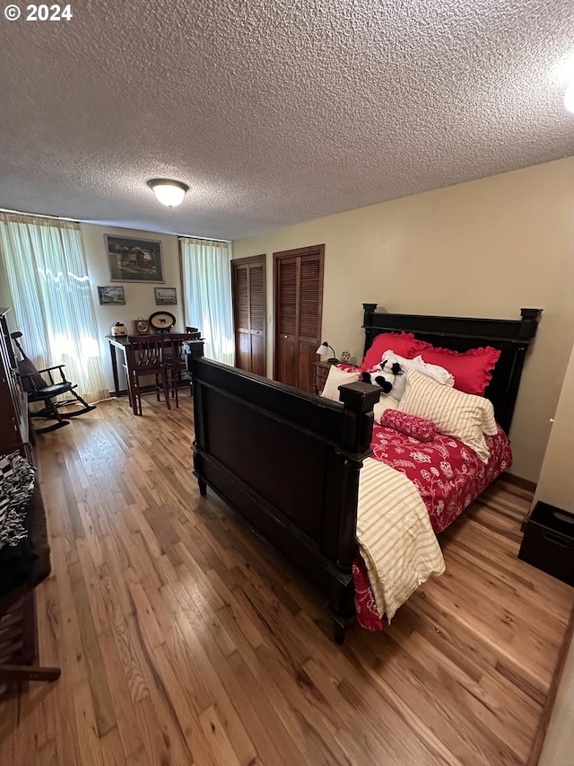 bedroom featuring a textured ceiling and wood-type flooring