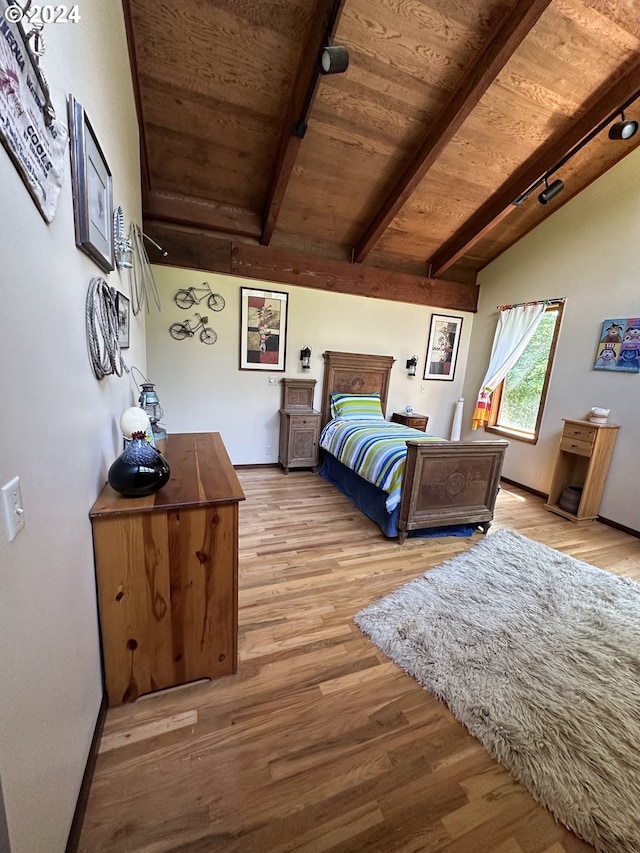 bedroom featuring wood ceiling, light hardwood / wood-style floors, and lofted ceiling with beams