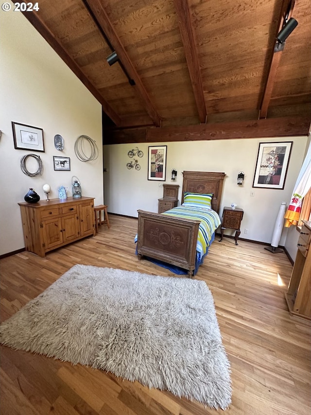 bedroom with light hardwood / wood-style flooring, wooden ceiling, and lofted ceiling with beams