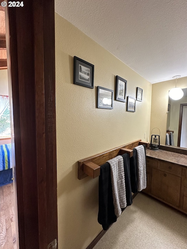 bathroom featuring a textured ceiling and vanity