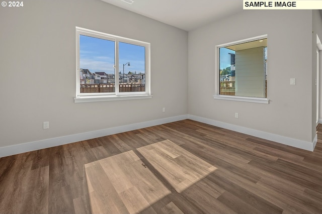 empty room with hardwood / wood-style floors