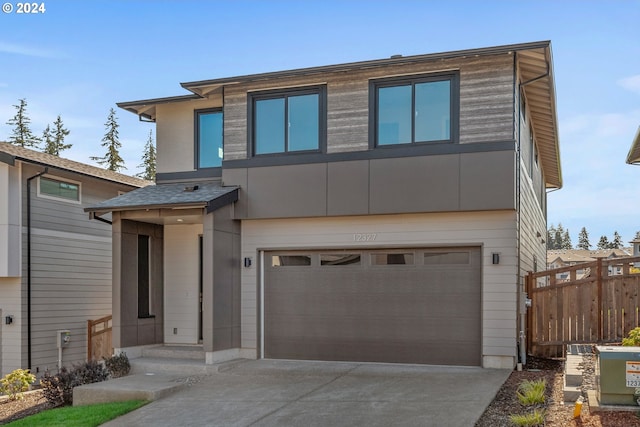 contemporary home featuring central AC and a garage