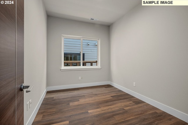 unfurnished room featuring dark hardwood / wood-style floors