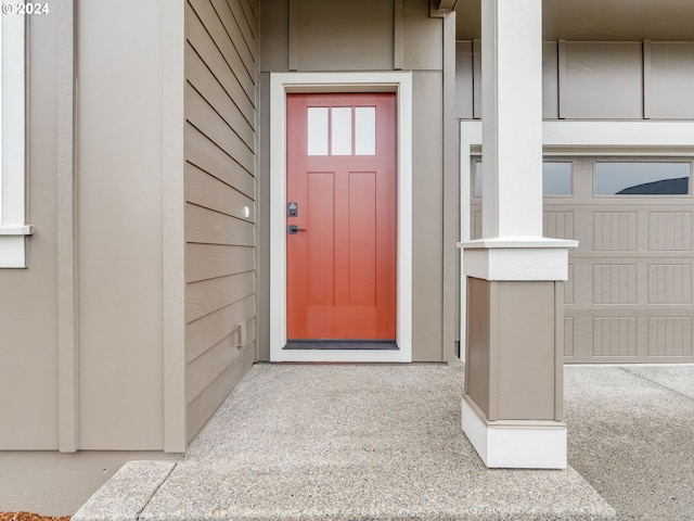 doorway to property with a garage