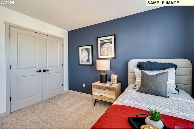 bedroom with a textured ceiling, a closet, baseboards, and carpet flooring