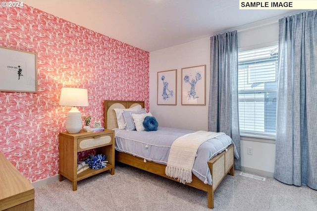 carpeted bedroom with wallpapered walls, baseboards, and visible vents