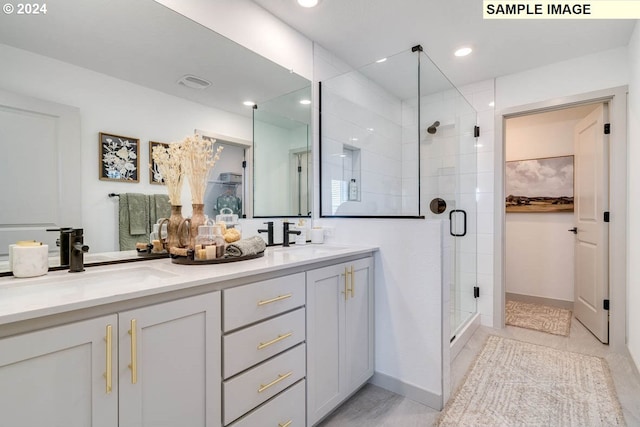 bathroom featuring double vanity, recessed lighting, a sink, and a shower stall