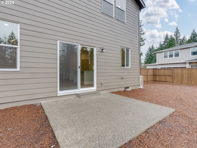 back of house featuring crawl space, fence, and a patio