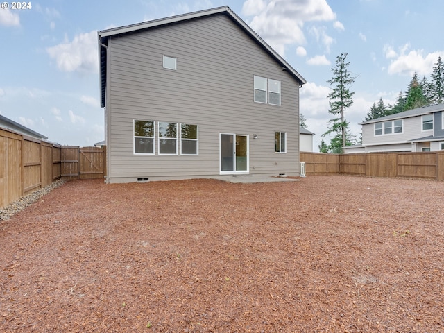 back of property featuring a fenced backyard